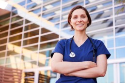 Healthcare worker woman smiling and crossing arms