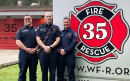 Station 35 sign next to three firefighters